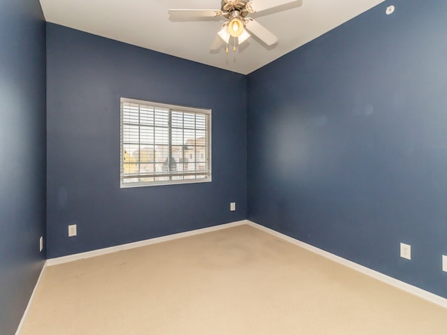 empty room featuring ceiling fan and carpet floors