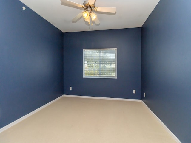 carpeted spare room with ceiling fan