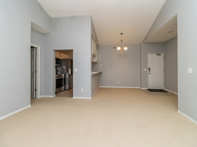 unfurnished living room with light carpet, a notable chandelier, and vaulted ceiling