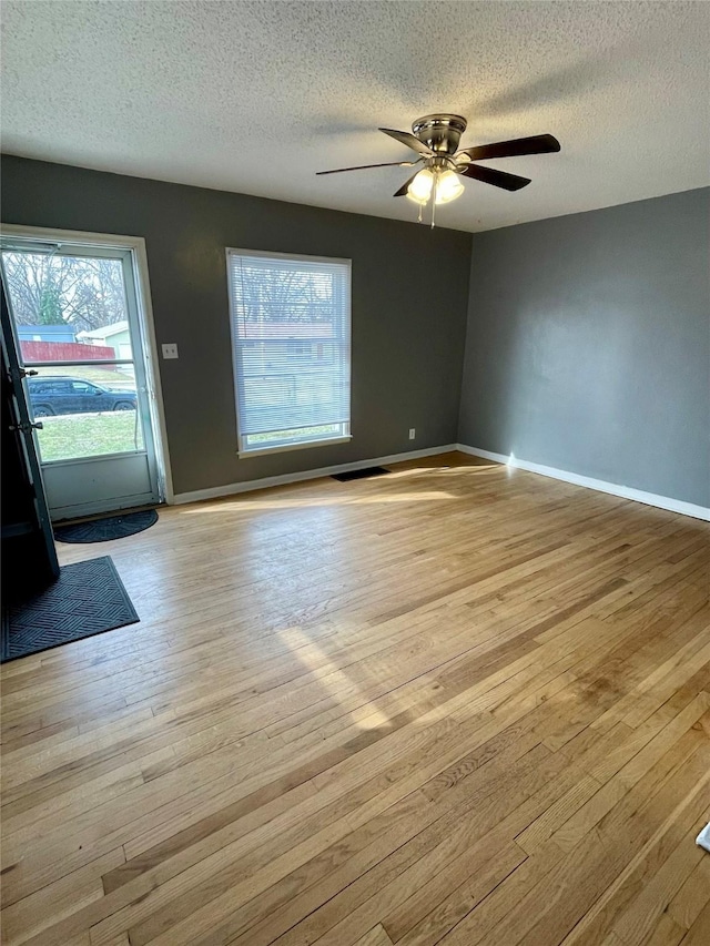 5711 Franklin Ave, Des Moines, IA 50310 - entryway featuring a textured ceiling, light wood-style flooring, healthy amount of natural light, and baseboards