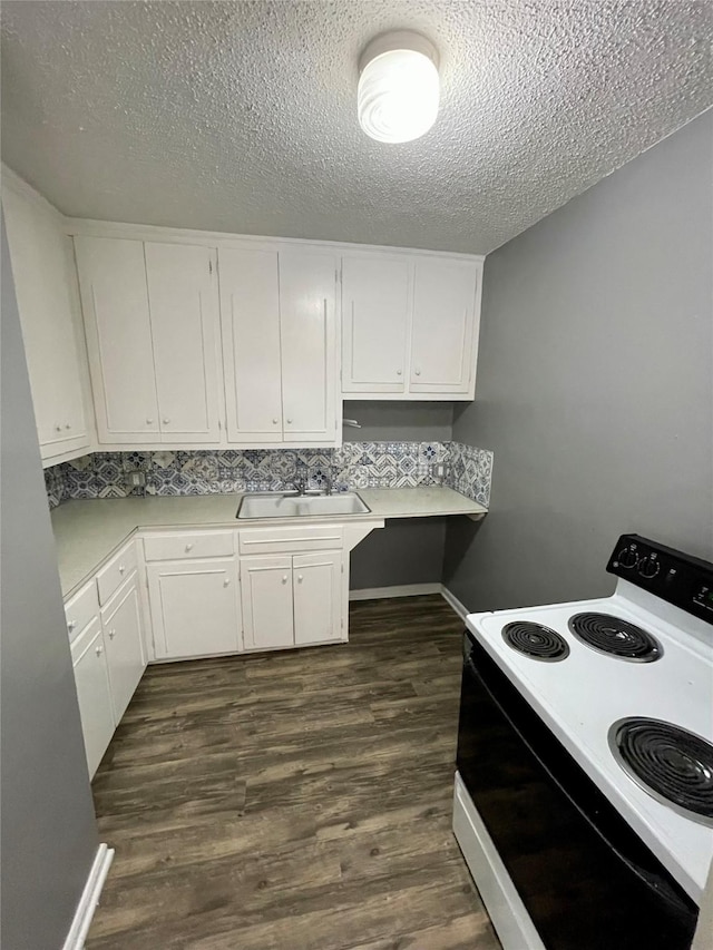 5711 Franklin Ave, Des Moines, IA 50310 - kitchen featuring range with electric stovetop, a sink, light countertops, white cabinets, and a textured ceiling
