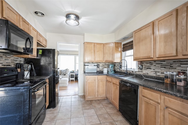 kitchen with black appliances, sink, plenty of natural light, and backsplash