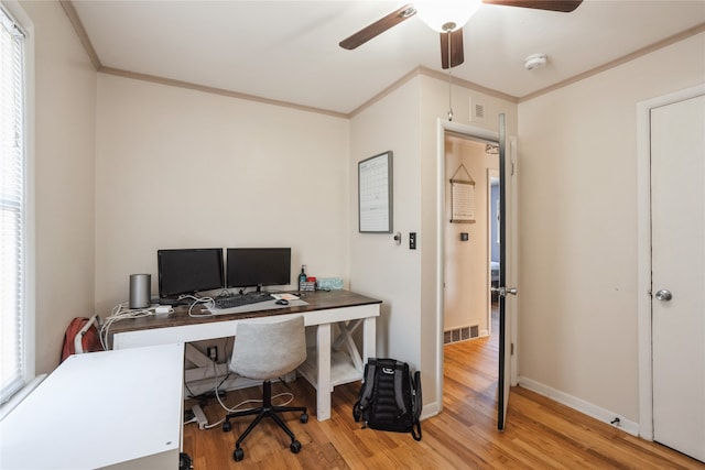 office area featuring a wealth of natural light, ornamental molding, light hardwood / wood-style flooring, and ceiling fan