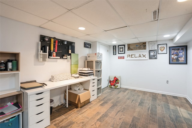 home office featuring a drop ceiling and wood-type flooring