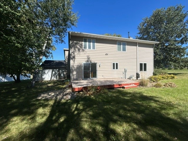 rear view of property with a lawn