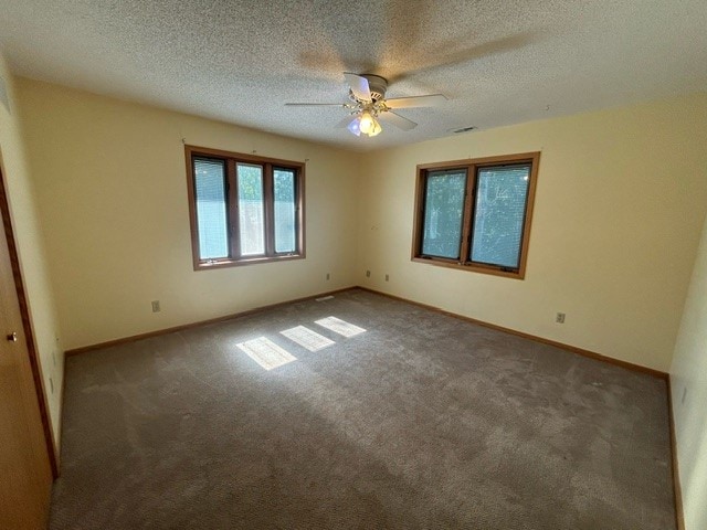 carpeted empty room featuring a textured ceiling and ceiling fan