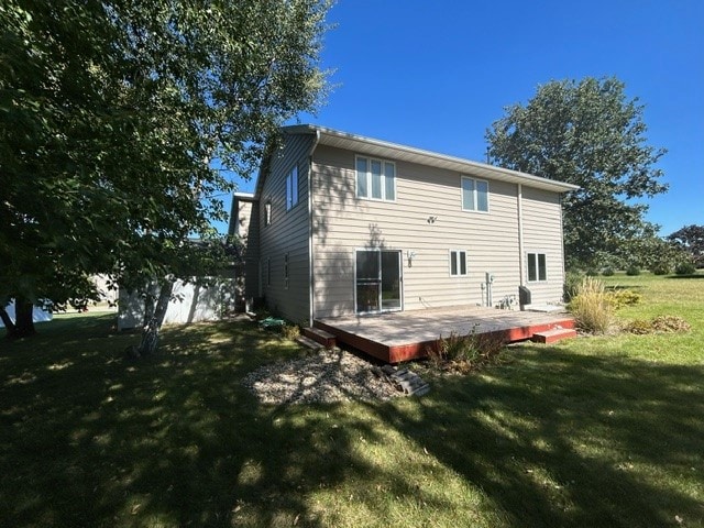 back of house featuring a yard and a deck