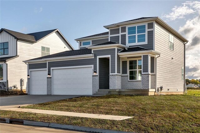 view of front of home with a front yard and a garage