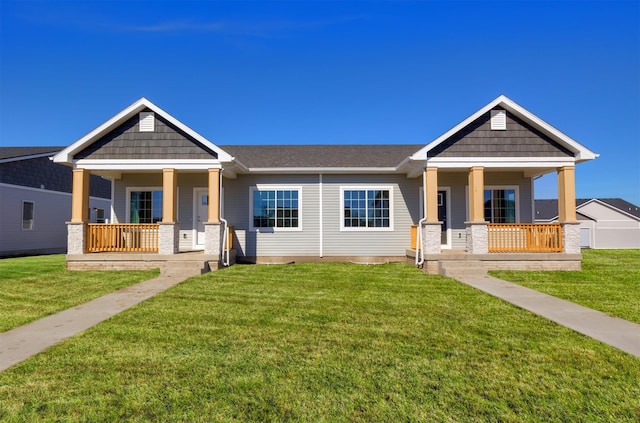 craftsman-style home with covered porch and a front lawn