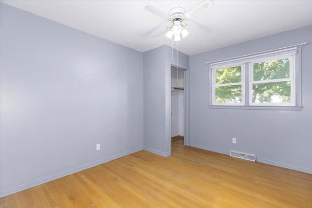 unfurnished bedroom featuring light hardwood / wood-style flooring, a closet, and ceiling fan