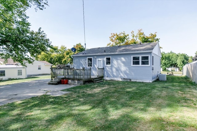 view of front of house featuring a front lawn, central air condition unit, a wooden deck, and a patio area