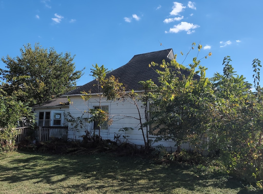 view of side of home with a yard