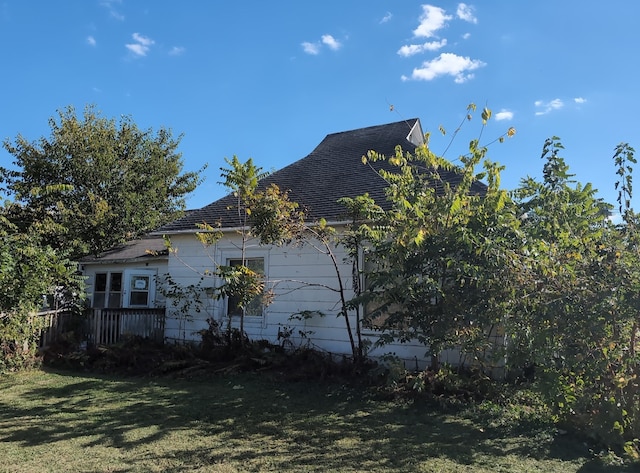 view of side of home with a yard