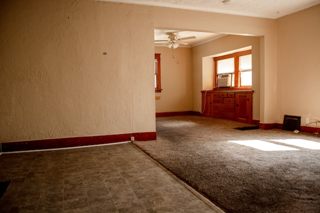 unfurnished room with ceiling fan, dark colored carpet, and ornamental molding