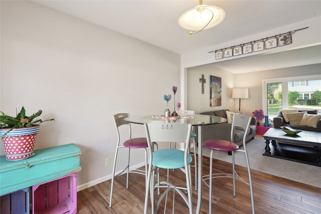 dining area with dark wood-type flooring