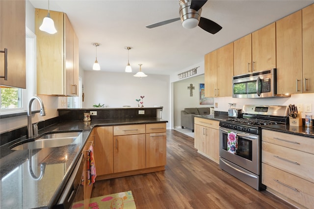 kitchen with stainless steel appliances, light brown cabinets, decorative light fixtures, and dark hardwood / wood-style flooring