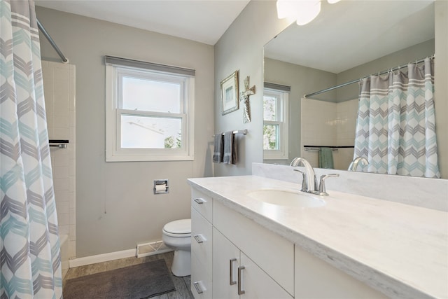 full bathroom with a healthy amount of sunlight, vanity, toilet, and shower / bath combo with shower curtain