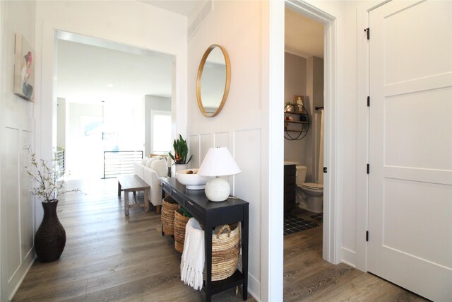 corridor with hardwood / wood-style floors