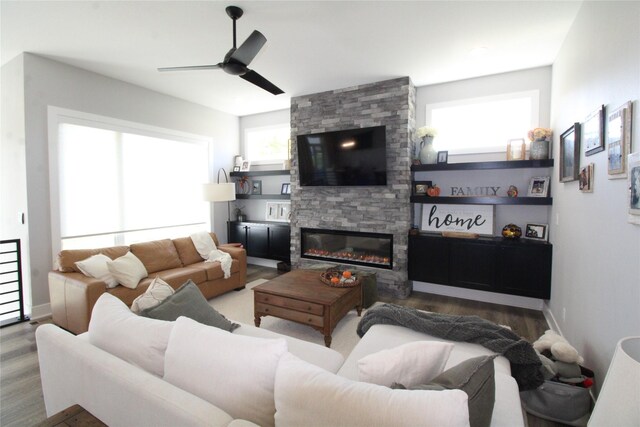 living room with hardwood / wood-style floors, a fireplace, and ceiling fan