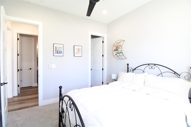 bedroom featuring light colored carpet and ceiling fan