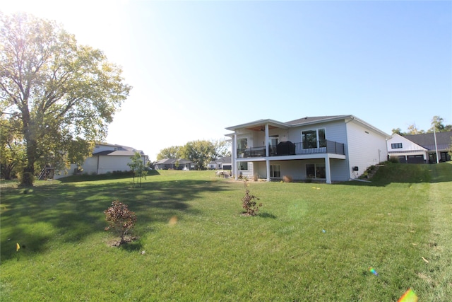 back of property featuring a lawn and a balcony