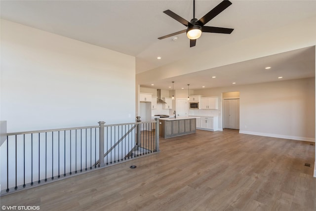 living room featuring light wood-type flooring and ceiling fan