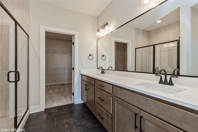 bathroom with tile patterned flooring, vanity, and an enclosed shower