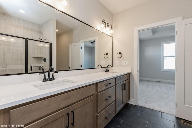 bathroom with tile patterned floors, vanity, and walk in shower