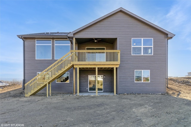 rear view of house featuring ceiling fan