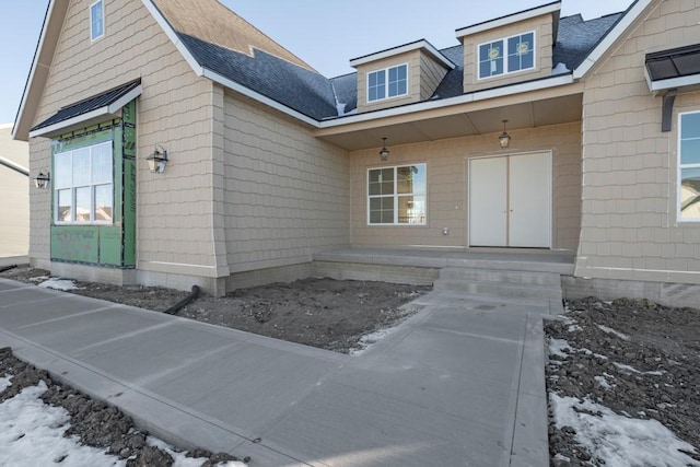 view of snow covered property entrance