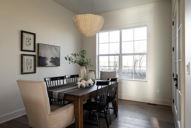 5807 NE Sherman Ct, Ankeny, IA 50021 - dining area featuring baseboards, dark wood-style floors, and a wealth of natural light