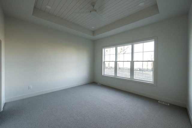 5807 NE Sherman Ct, Ankeny, IA 50021 - carpeted empty room with baseboards, ceiling fan, a tray ceiling, and visible vents
