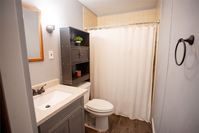 bathroom with toilet, vanity, and a shower with shower curtain