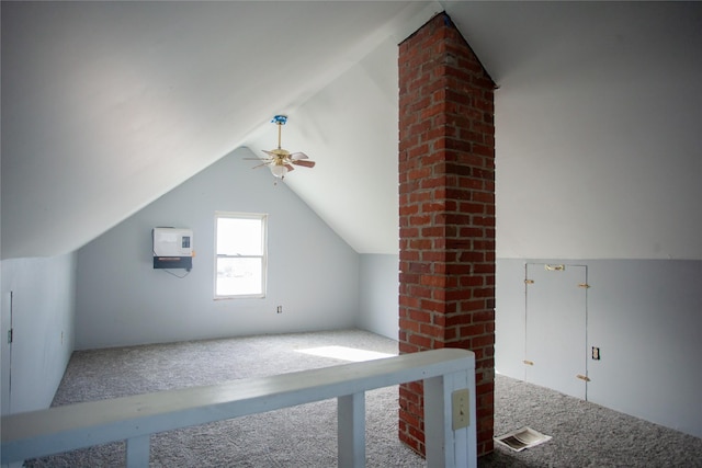 additional living space with ceiling fan, carpet, and lofted ceiling