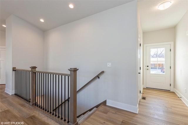 staircase with hardwood / wood-style flooring