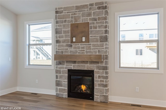 interior details featuring a fireplace and hardwood / wood-style floors