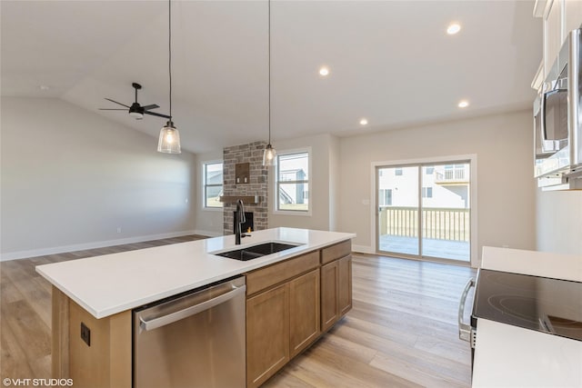 kitchen with sink, vaulted ceiling, ceiling fan, an island with sink, and appliances with stainless steel finishes