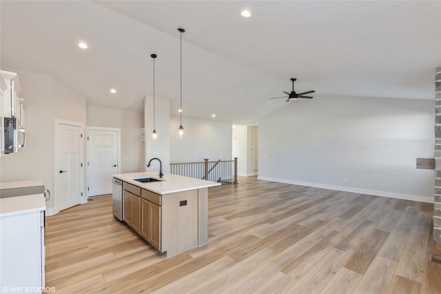 kitchen featuring stainless steel dishwasher, decorative light fixtures, lofted ceiling, a kitchen island with sink, and ceiling fan