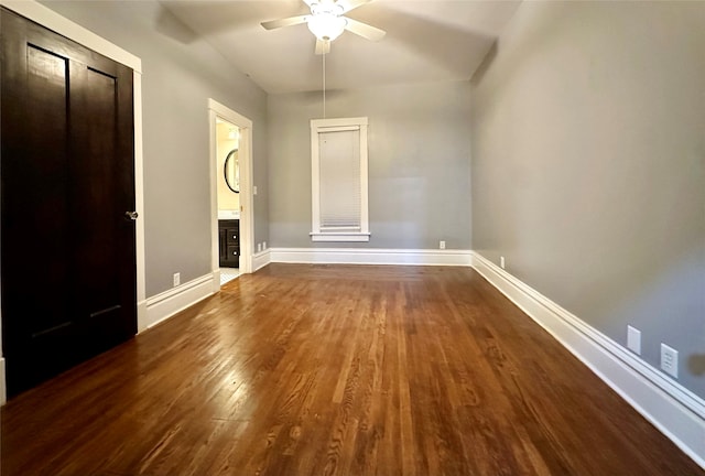 unfurnished bedroom with ensuite bath, ceiling fan, and dark hardwood / wood-style floors