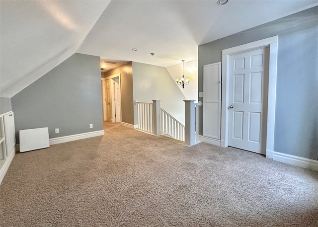 additional living space featuring carpet, vaulted ceiling, and a notable chandelier