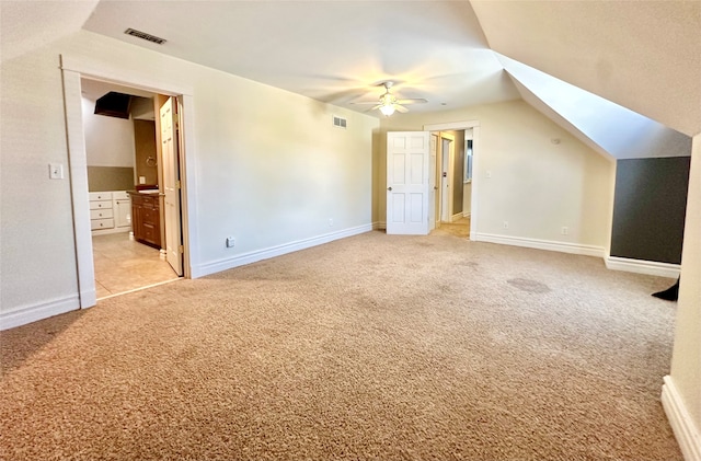 additional living space featuring vaulted ceiling, ceiling fan, and light colored carpet