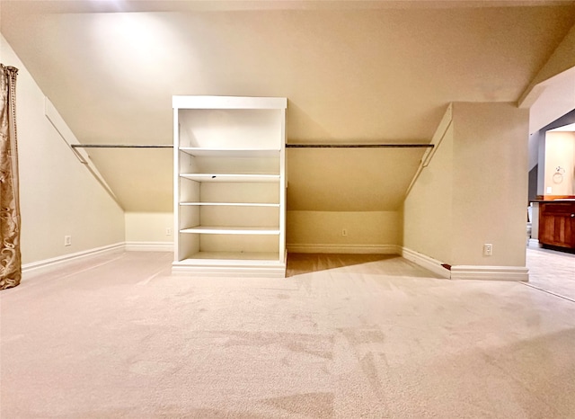 spacious closet featuring lofted ceiling and carpet