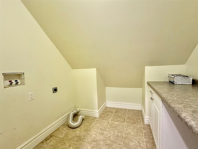 washroom with washer hookup, hookup for an electric dryer, and cabinets