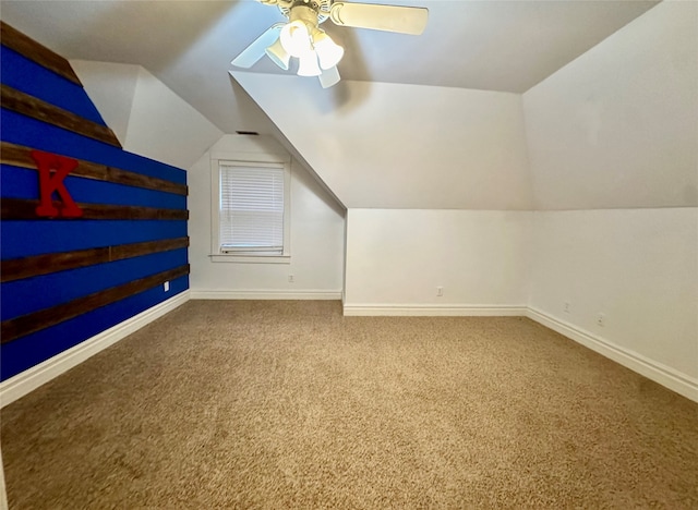 additional living space featuring vaulted ceiling, ceiling fan, and carpet flooring