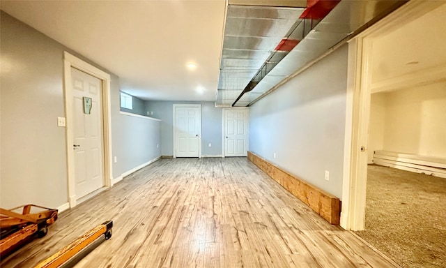 basement with hardwood / wood-style flooring