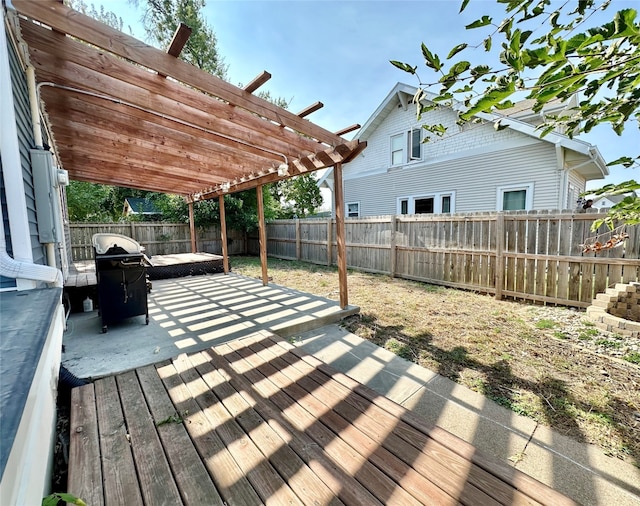 wooden terrace featuring grilling area, a pergola, and a patio area