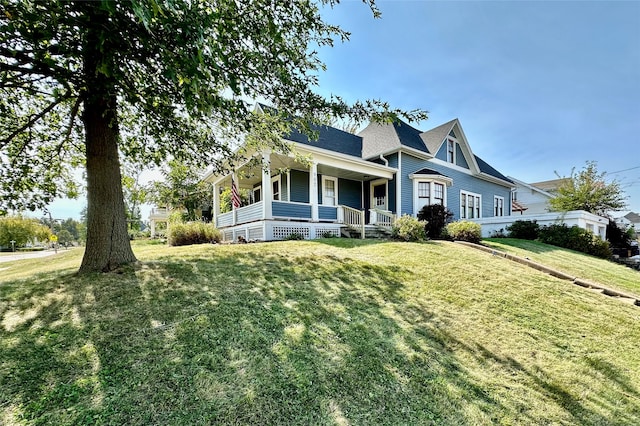 view of front facade with a front yard and a porch