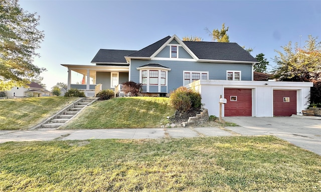 view of front of property with a front yard, a porch, and a garage