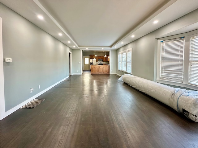 unfurnished living room with dark wood-type flooring