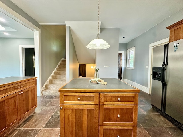 kitchen featuring stainless steel fridge, a center island, and decorative light fixtures